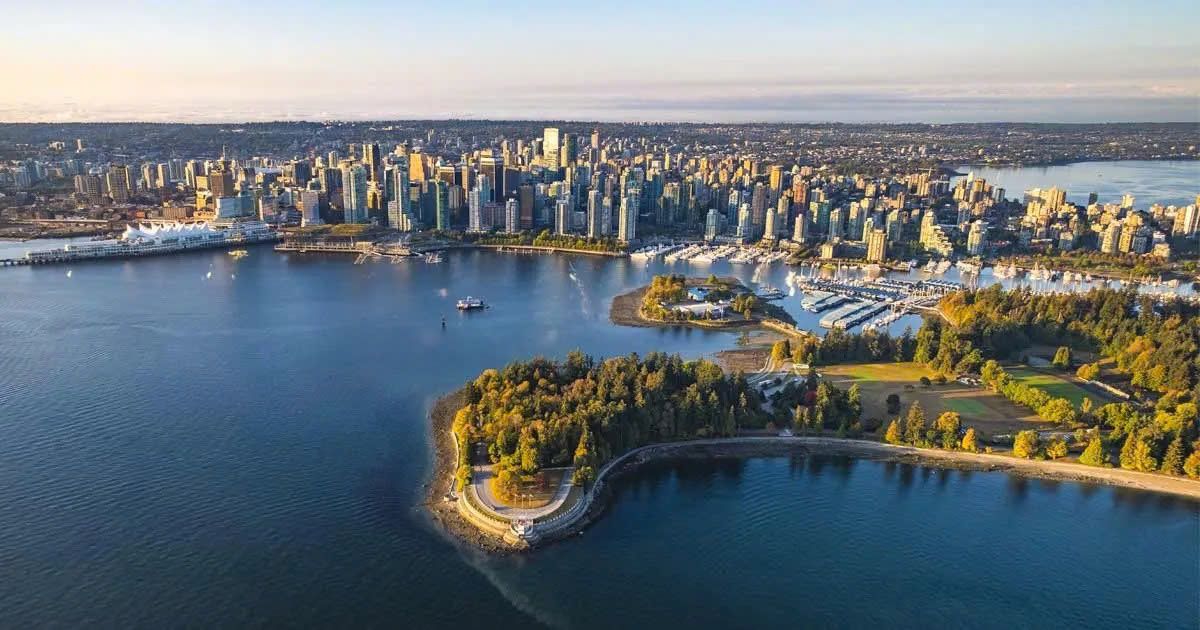 Waterfront walking path in Vancouver with mountains and city skyline in the distance